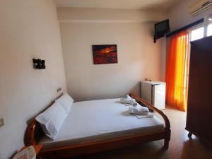 a small bedroom with a bed in a room at Hotel Matina in Kamena Vourla