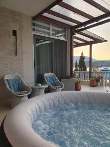 a hot tub on the patio of a house at Apartman Relax Čelebići in Konjic