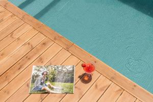 a picture of a woman next to a swimming pool at Lemonanthos Villa in Káto Kalésia
