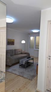 a living room with a couch and a table at Druskininkų Pasaga in Druskininkai +42 photos