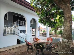 a group of chairs and a table in front of a building at WanKi Homestay in Kuala Terengganu +11 photos