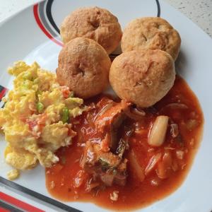 a plate of food with a plate of breakfast foods at Nature in portland Eco Villas in Port Antonio