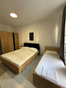 a bedroom with two beds in a room at Flat in Orikum Beach in Orikum
