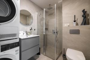 a bathroom with a shower and a toilet and a sink at F-Apartments - Emperor Size Bed, City Center, Contactless in Tartu +33 photos