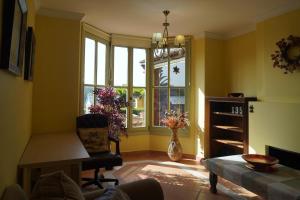 a living room with yellow walls and a window at Chalet Adosado for Rent in Sotogrande in San Roque