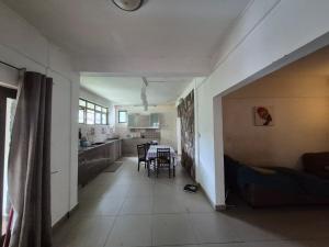 una cucina e un soggiorno con tavolo e sedie di Pointe aux Piments Residence a Pointe-aux-Piments