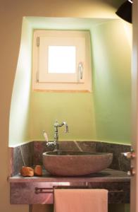 a sink in a bathroom with a window at Porta Di Marina in Chios +26 photos