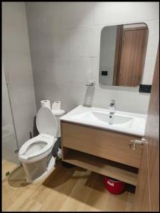 a bathroom with a toilet and a sink at Central Park Down Town F2 in Punta Cana +3 photos