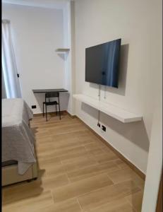 a bedroom with a flat screen tv on a wall at Central Park Down Town F2 in Punta Cana