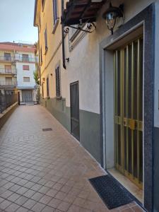 an empty alley with a door to a building at SL Home in Scalea
