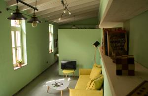 a living room with a couch and a tv at Porta Di Marina in Chios