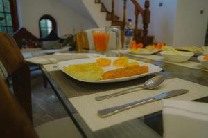 a table with a plate of breakfast food on it at Kandy Villa in Kandy
