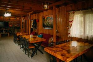 a dining room with wooden tables and chairs at Elagza Dag Evi in Rize