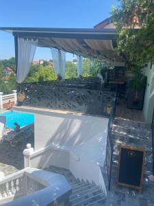 a view of a swimming pool from a house at City view & pool apartment in Niš