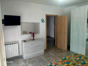 a bedroom with a dresser and a mirror at Perla Marina in Montesilvano