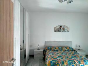 a bedroom with a bed with a picture on the wall at Perla Marina in Montesilvano
