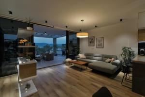 a living room with a couch and a table at Villa Hedona in Komarna
