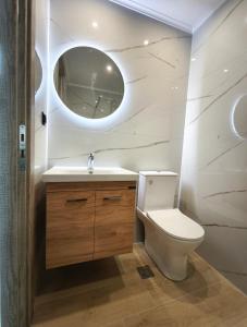 a bathroom with a toilet and a sink and a mirror at Araxovoli Studios - Aραξοβόλι Lefkada in Tsoukalades