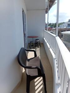 a balcony with two chairs and a table at Russ Apartment 2 Diagonal comando in San Andrés