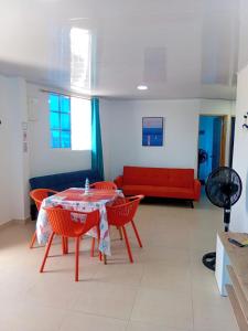 a living room with a table and chairs and a couch at Russ Apartment 2 Diagonal comando in San Andrés