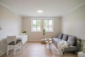 a living room with a couch and a table at Cozy apartment - Walking distance to Kristiansand city center in Kristiansand +12 photos