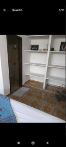 a room with white shelves in a room at Botucatu in Botucatu +1 photo