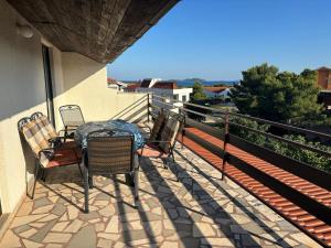 a patio with chairs and a table on a balcony at Apartments Radulović in Biograd na Moru