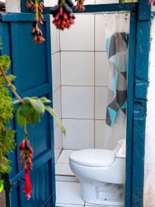 a bathroom with a blue door and a toilet at La Estación San Pedro in Cusco