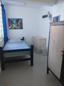 a bedroom with a bed and a painting on the wall at Casa Lina in Montería