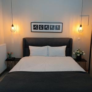 a bedroom with a large bed with two night stands at Moris Luxury Apartments 1 in Thessaloniki