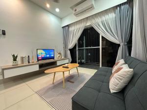 a living room with a couch and a tv and a table at KL City 3BR 3Bath Condo , Razak city ,TV box & Pool in Kuala Lumpur