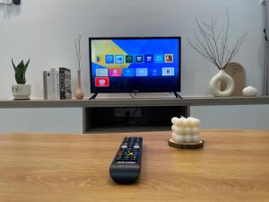 a remote control sitting on a table next to a television at KL City 3BR 3Bath Condo , Razak city ,TV box & Pool in Kuala Lumpur