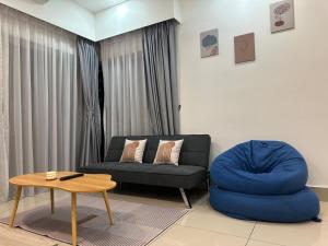 a living room with a couch and a coffee table at KL City 3BR 3Bath Condo , Razak city ,TV box & Pool in Kuala Lumpur