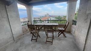 a table and chairs on a balcony with a view at Charming Villa in Cappadocia in Uçhisar