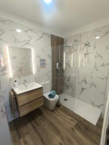 a bathroom with a toilet and a sink and a shower at CASA CANDELARIA,PARKING,AIR,WIFi in Candelaria +35 photos