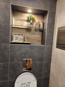 La salle de bains est pourvue de toilettes et d'étagères. dans l'établissement Lili Azur beach appaartment, à Varna 2 autres photos