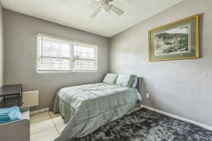 a bedroom with a bed and a picture on the wall at Amazing 'Hot Tub' Home Minutes To Hospitals & Beaches in Palmetto