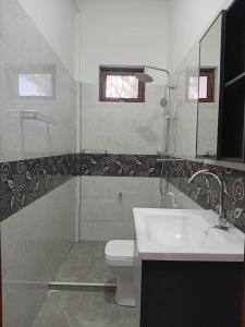 a bathroom with a toilet and a sink at MSGuest House in Jaffna +30 photos