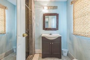 a bathroom with a sink and a mirror at Amazing 'Hot Tub' Home Minutes To Hospitals & Beaches in Palmetto +27 photos