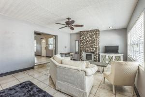 a living room with a couch and a tv at Amazing 'Hot Tub' Home Minutes To Hospitals & Beaches in Palmetto