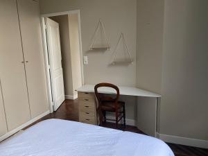 a bedroom with a bed and a desk and a chair at Le Philibert Roux in Auxerre
