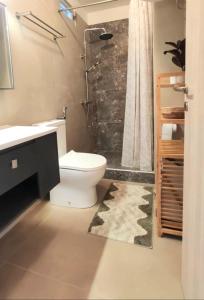 a bathroom with a white toilet and a shower at Julia's Home in Patitiri +16 photos