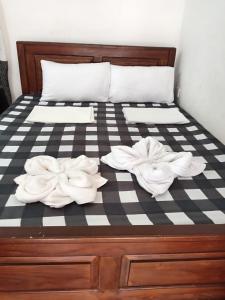 a bed with two white towels on it at TrincoBeCoolGuest & Hostel in Trincomalee