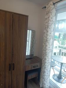 a room with a cabinet and a table and a window at Luxury Budget one Bedroom with living room and Kitchen Rest and fly at Amani Grand Resort in Pusok