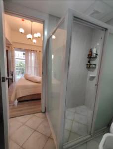 a room with a glass door leading to a bedroom at Luxury Budget one Bedroom with living room and Kitchen Rest and fly at Amani Grand Resort in Pusok