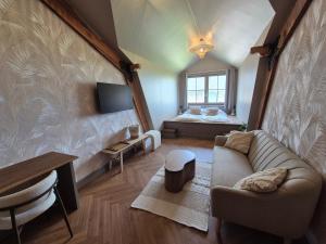 Μια τηλεόραση ή/και κέντρο ψυχαγωγίας στο Bed and Breakfast Zomerzicht