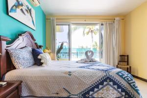 a bedroom with a bed with a view of the ocean at Cheerful 4 Bedroom house with Swimming Pool in Mezcales +38 photos