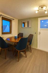 a dining room with a table and chairs and a window at Small House park free at street in Stuttgart