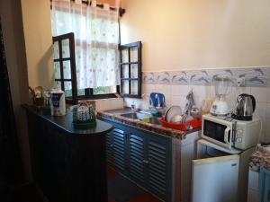 a kitchen with a sink and a microwave at Vera Cruiz one bedroom CBD in Malindi
