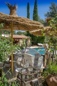 a bird cage in a yard with a pool at Villa Des oliviers in Le Beausset